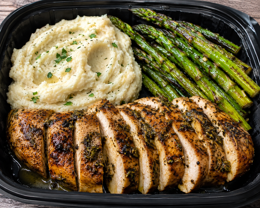 Grilled lemon herb chicken breast with mash potatoes and grilled asparagus.